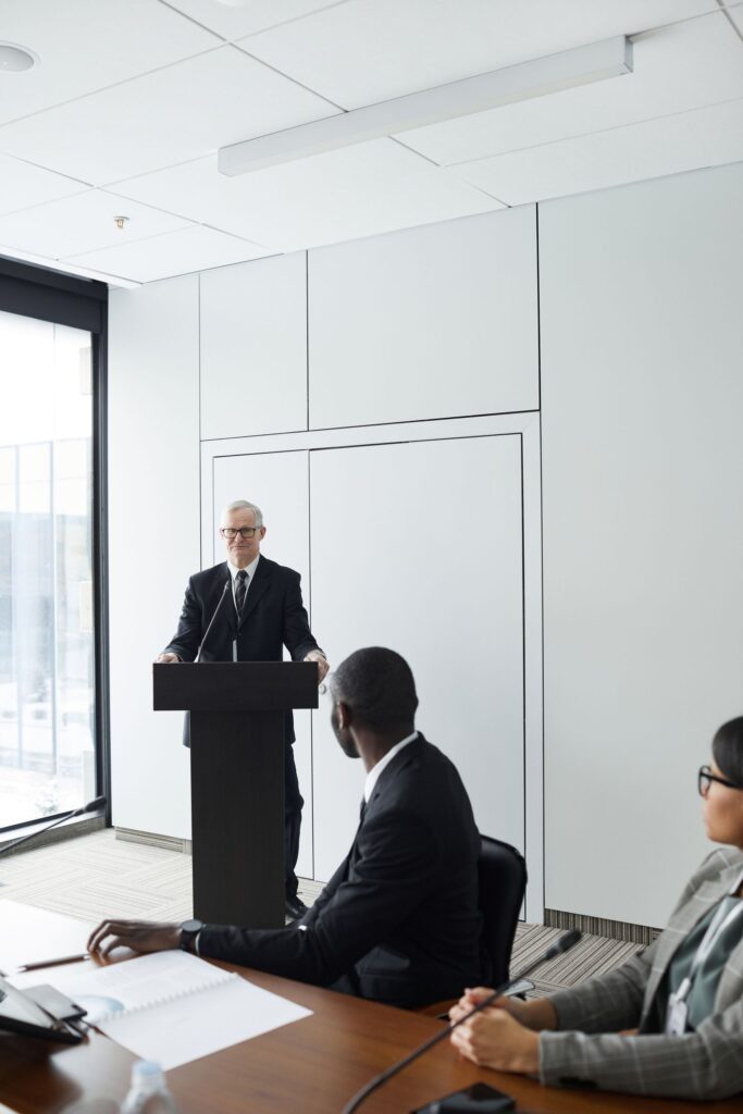 A speaker presenting to an audience of healthcare professionals at a seminar