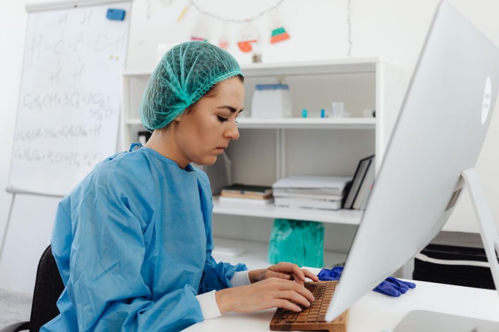 A clinician entering patient information at a hospital computer workstation
